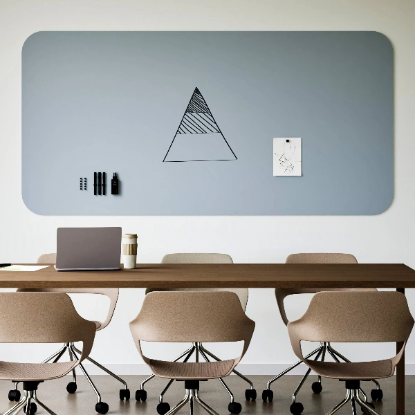 Graues Chameleon Curve Whiteboard mit Zeichnung und magnetischem Zubehör über einem Konferenztisch mit Laptop und Bürostühlen.