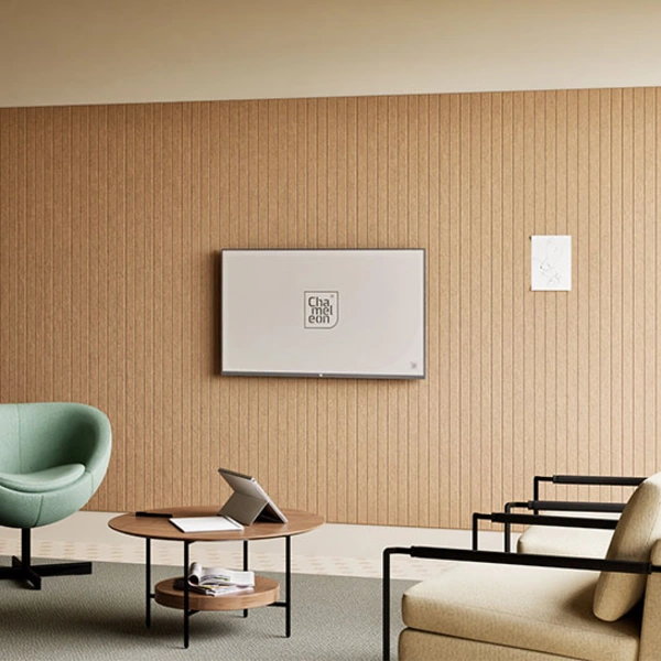 Moderner Loungebereich mit Chameleon Sharp Acoustics Wall Panels, Wandboard, Sesseln und Tisch vor einer strukturierten Akustikwand.